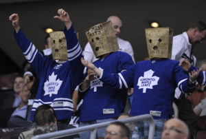 Toronto Maple Leafs fans wear paper bags on their heads during the third period of their NHL hockey game against the New York Islanders in Toronto March 20, 2012. REUTERS/Mike Cassese (CANADA - Tags: SPORT ICE HOCKEY)